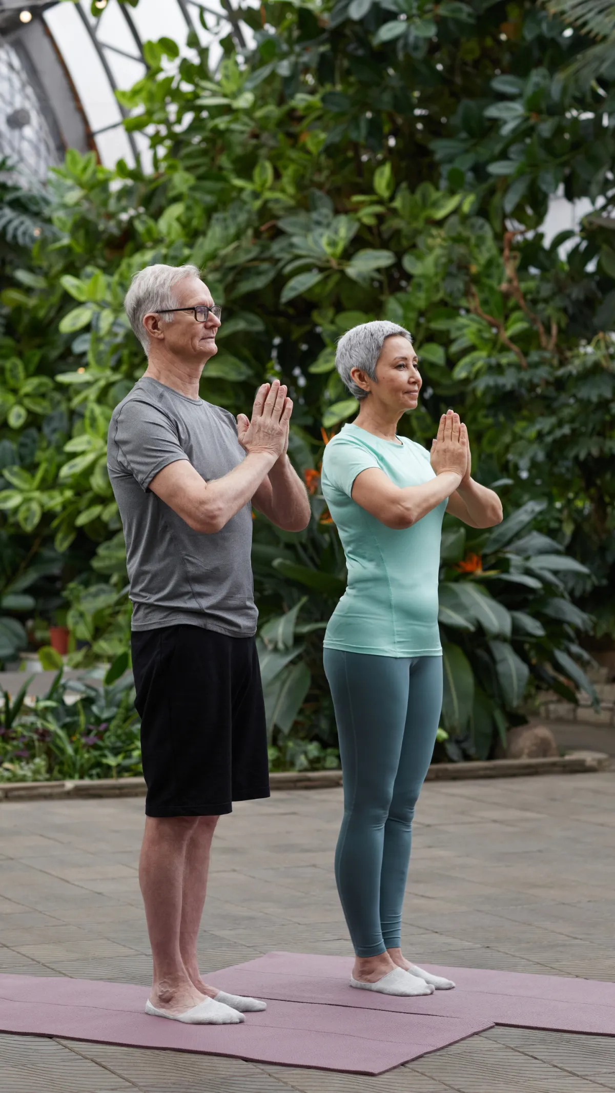 Woman smiling and reading a book outdoors