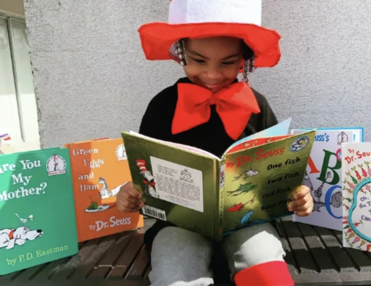 Boy picks paper out of different colored liquids