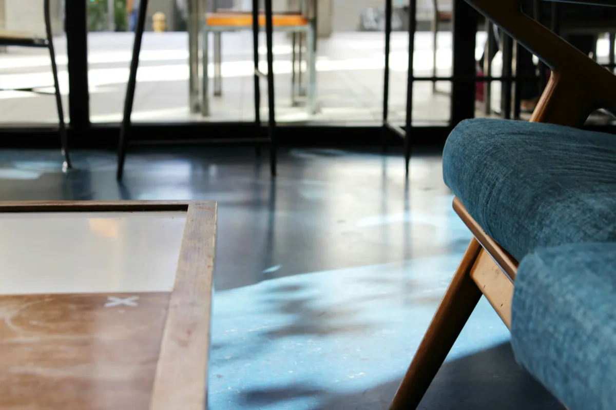 dark blue epoxy floor in a store with a cushioned chair