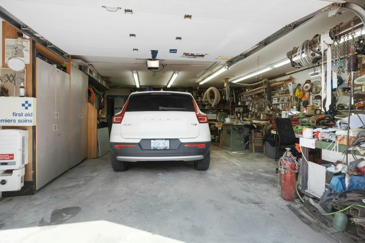 unsealed concrete in garage with car and floor stains