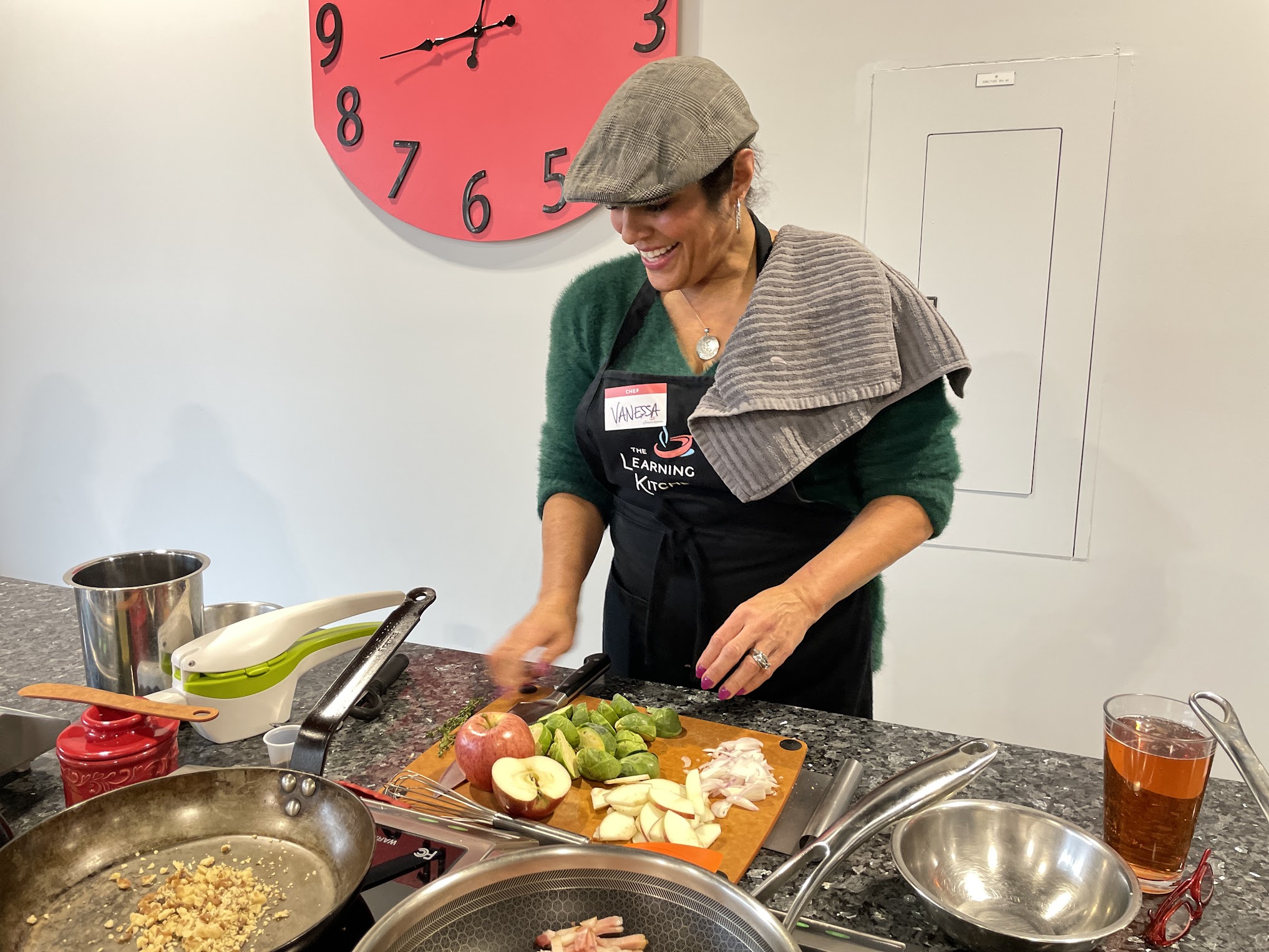 Guest preparing fresh ingredients during interactive cooking class at The Learning Kitchen culinary workshop