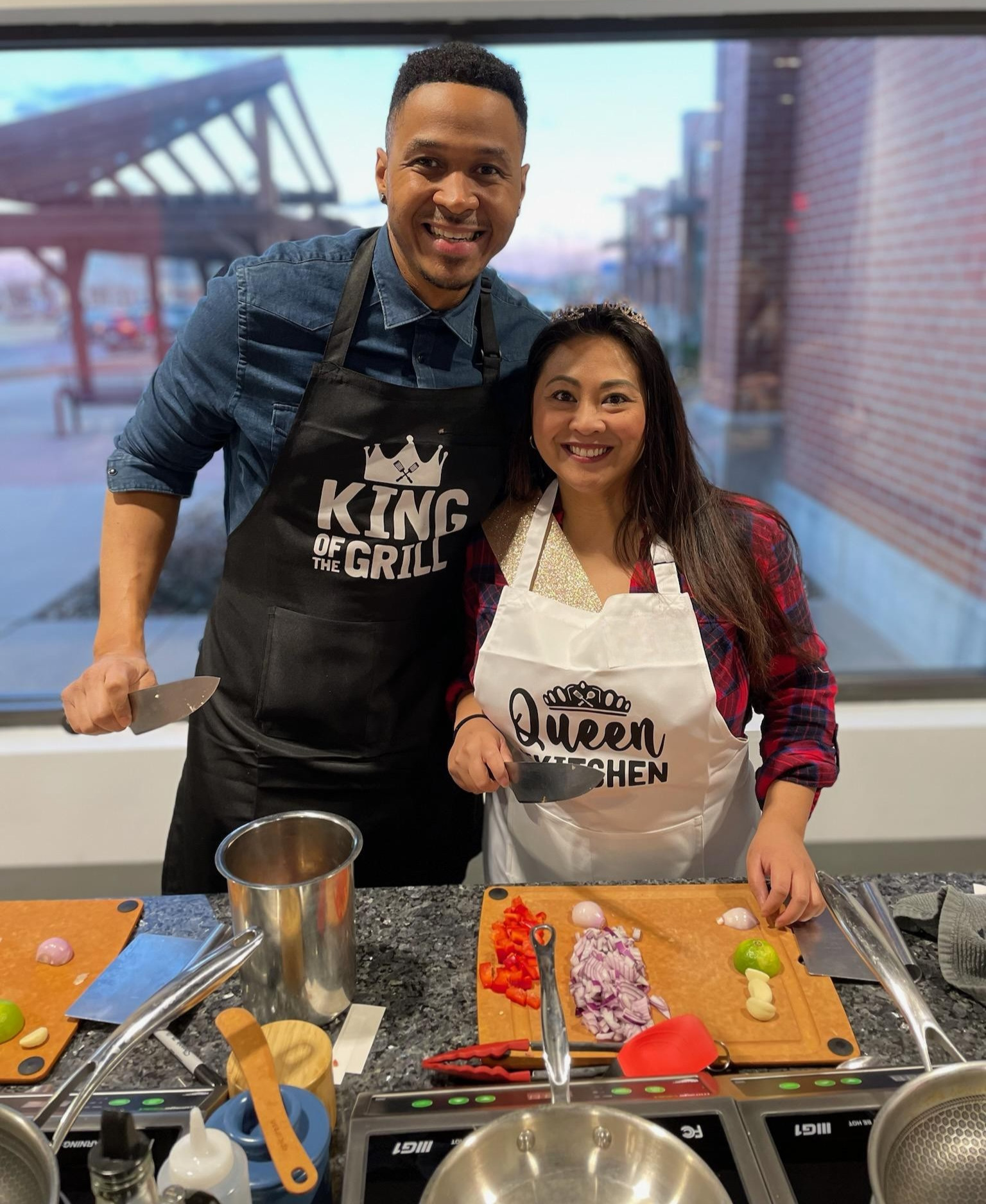 Couple enjoying an exclusive culinary experience for two during a hands-on cooking class at The Learning Kitchen