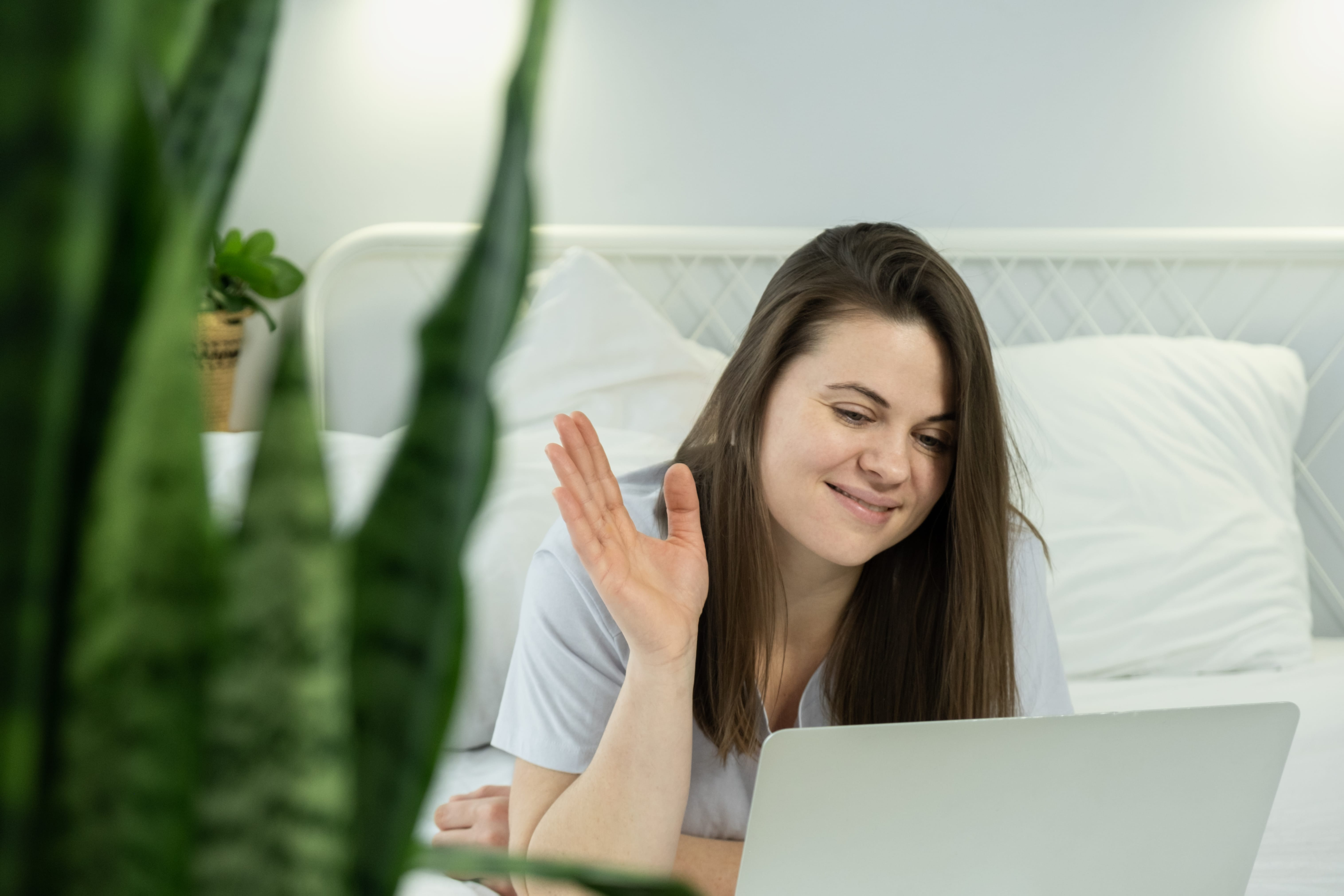 Woman attending online wellness coaching session from home using a laptop, representing virtual health consultation, personalized support, and healthy lifestyle guidance.