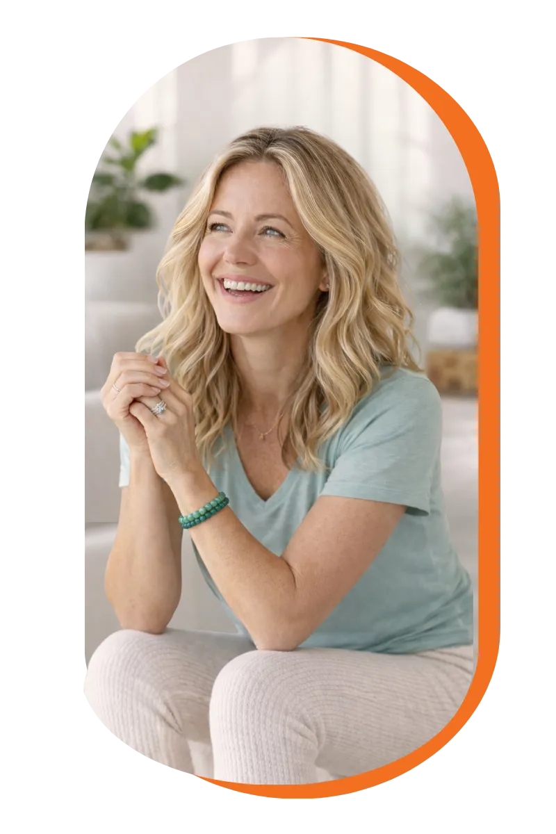 A smiling woman wearing a blue shirt and white pants, exuding a cheerful and friendly demeanor.