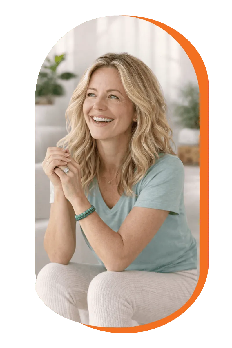 A smiling woman wearing a blue shirt and white pants, exuding a cheerful and friendly demeanor.