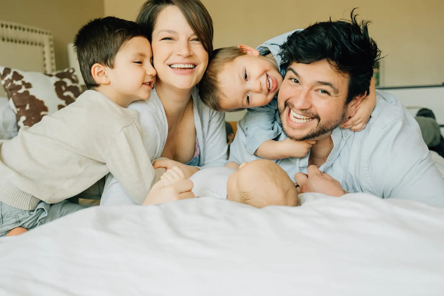 A warm, inviting office scene with a diverse small business owner and a coach sharing a friendly handshake across a table, both smiling, with soft natural light and calming blue accents. The setting radiates trust and approachability, reflecting an amiable, supportive atmosphere.