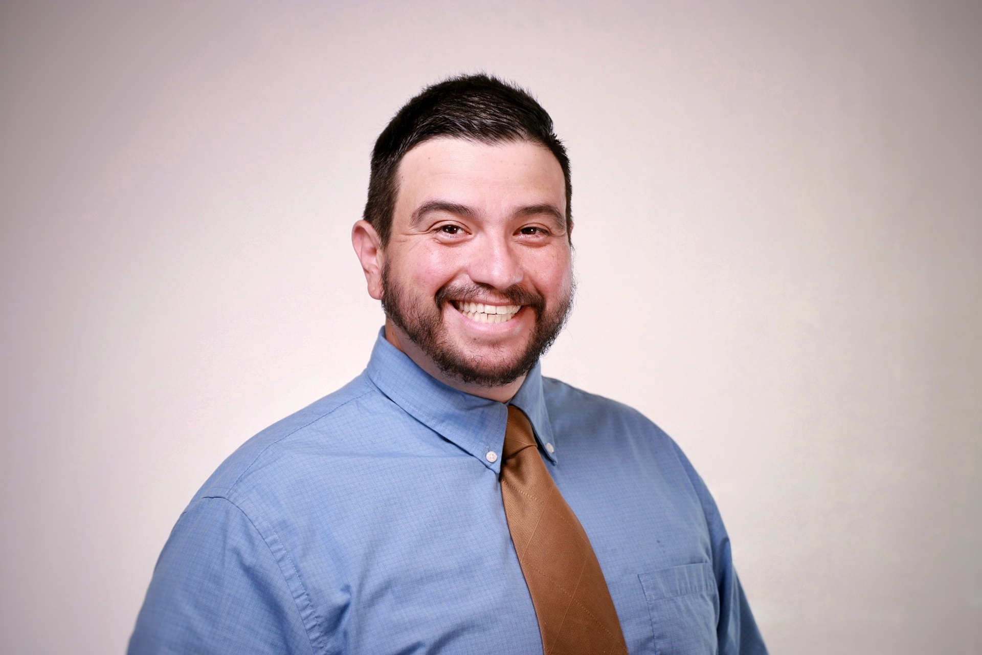 A gentle, approachable coach listening attentively to a small business owner in a cozy, plant-filled workspace. Both are relaxed, with open body language, and the environment feels nurturing and safe, emphasizing empathy and understanding.