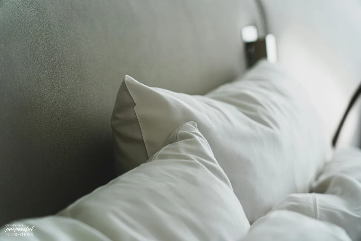 white pillows against a grey headboard