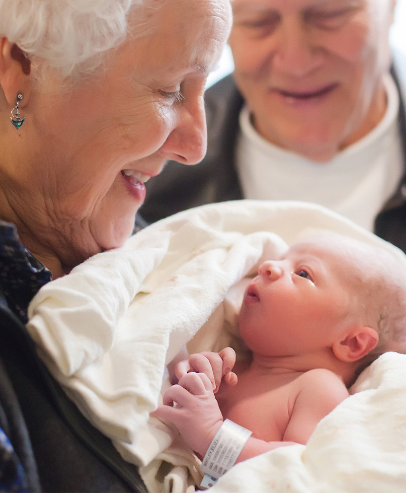 grandparents holding newborn grandchild future planning