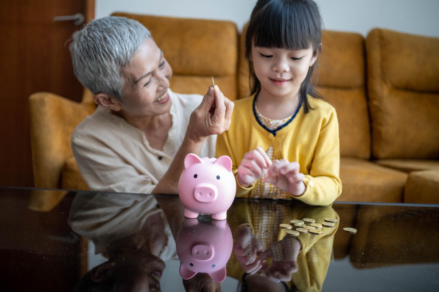 grandmother teaching grandchild about saving money