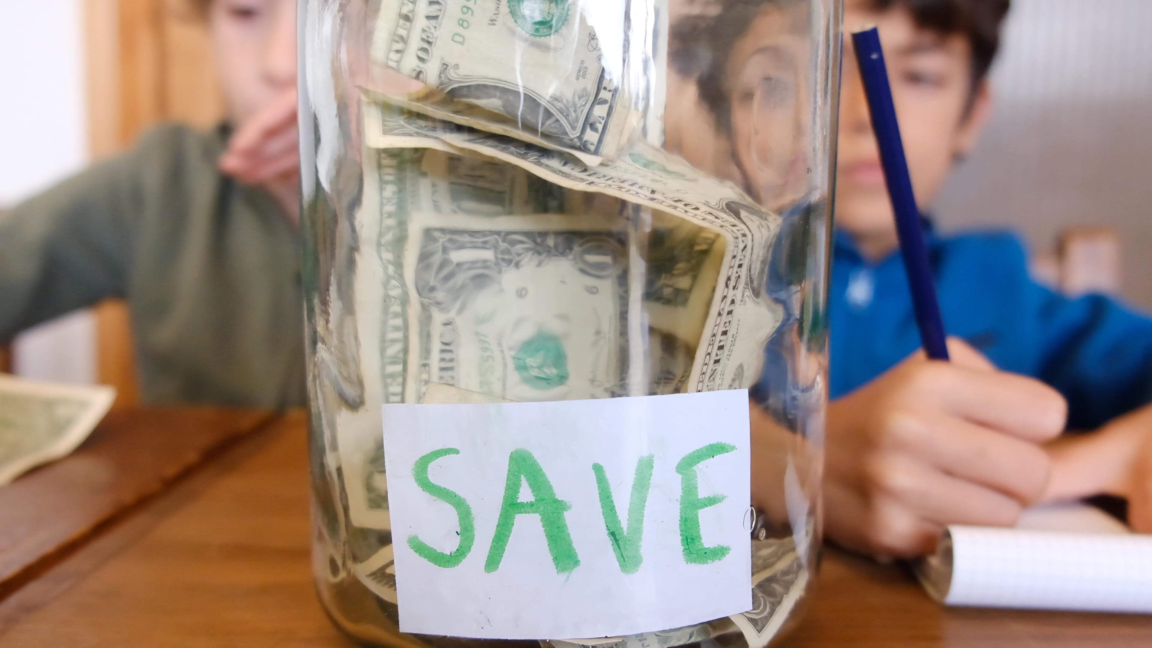 child saving coins piggy bank financial education