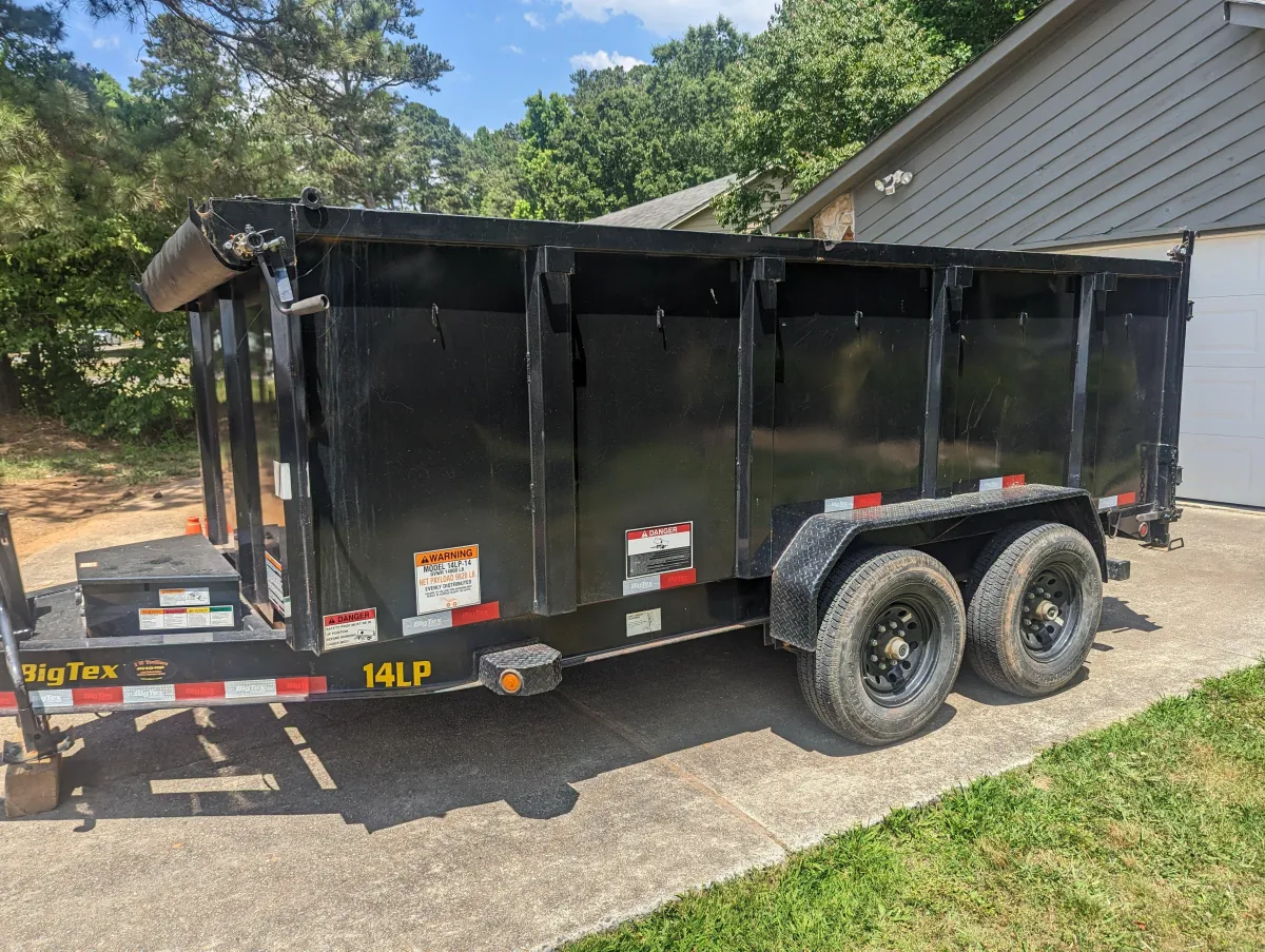 "Satisfied customer in Acworth, GA using County Line Dumpster Rentals for efficient home cleanout."