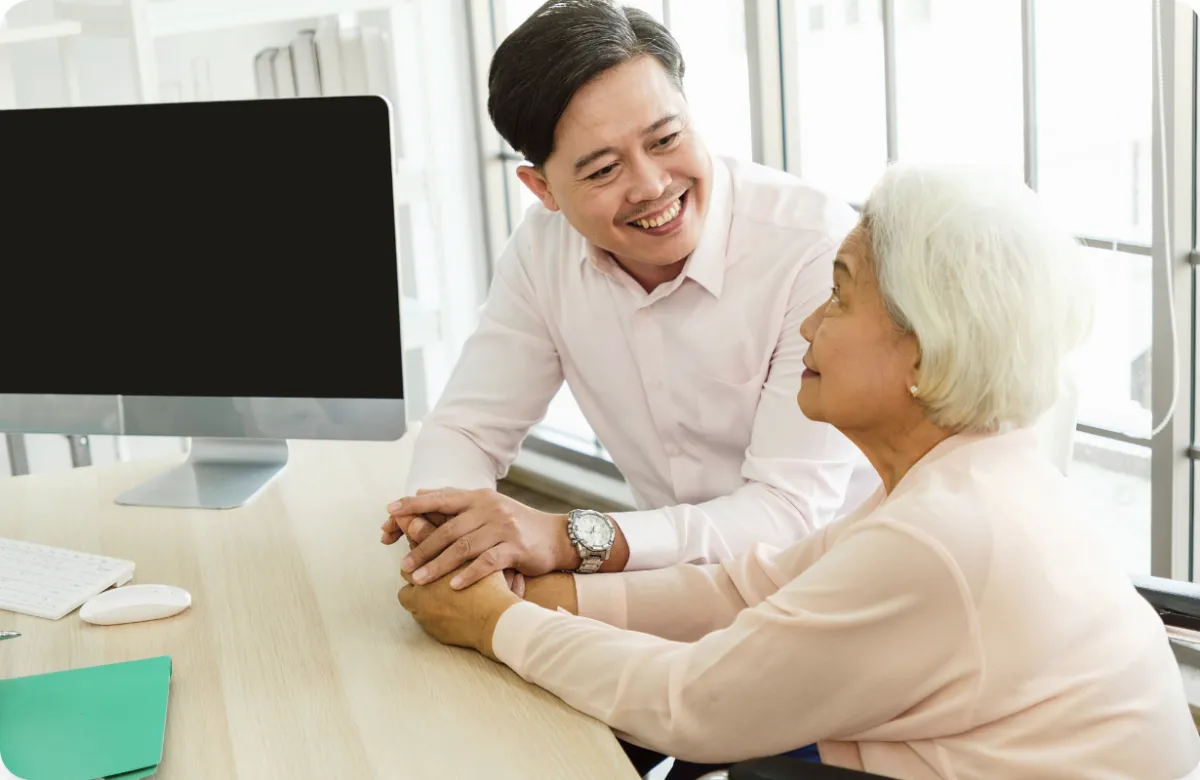 Caring ElderBridge consultant with trusting senior woman