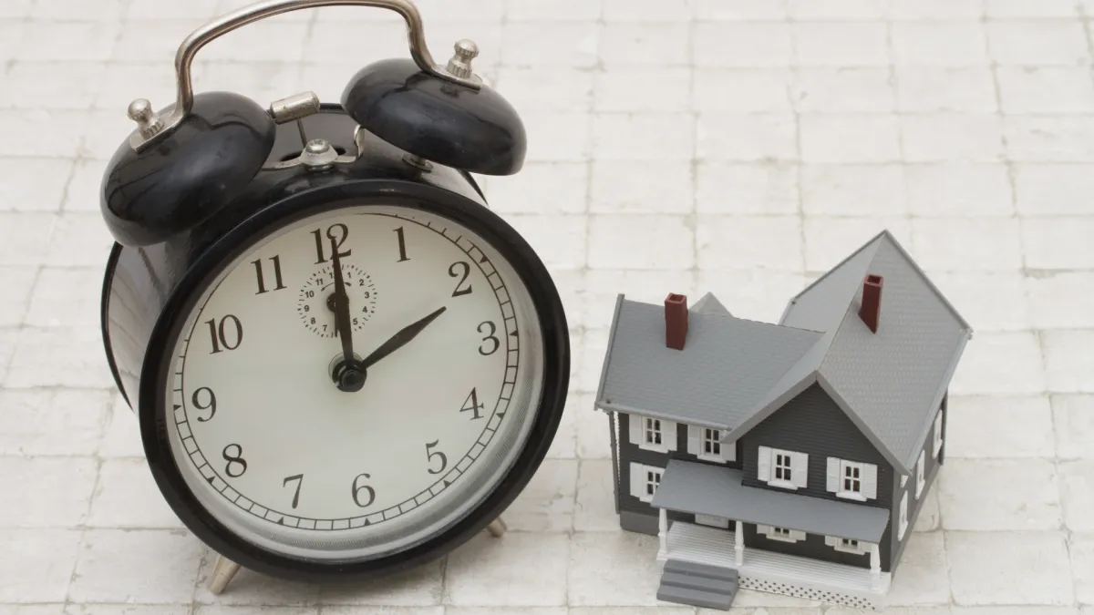 clock next to miniature house