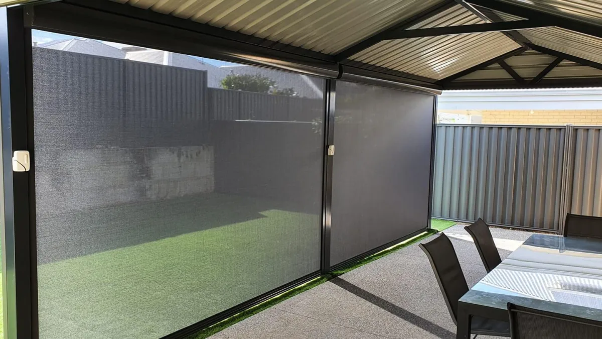 Retractable outdoor blinds creating shade for a patio space