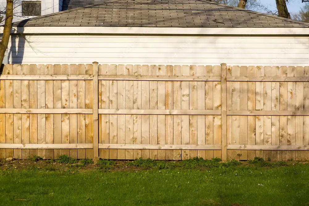 Picture of a skilled fence installer securing a chain-link fence - "Professional fence installer setting up a chain-link fence."