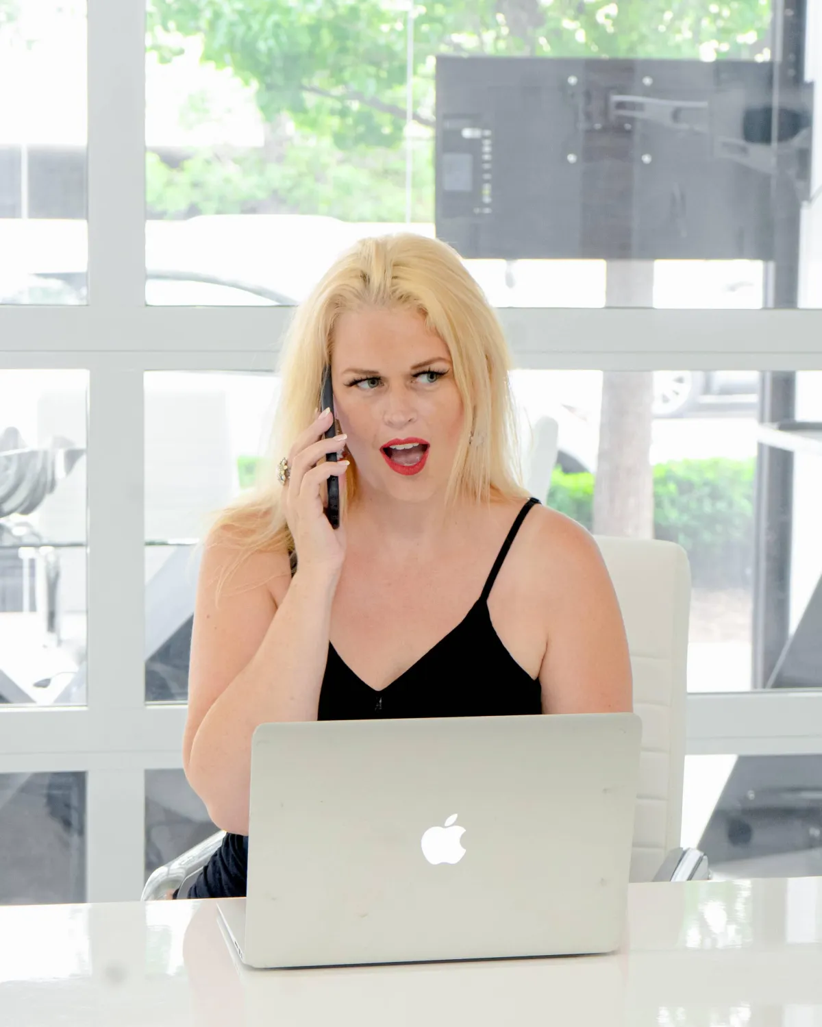 Kiki Sloan on a phone call in a Denver Real Estate office.