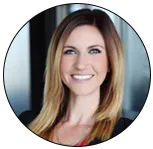 Doelle Peters of Metro Mortgage Group portrait - smiling with long dark hair, standing outdoors in a softly blurred background.