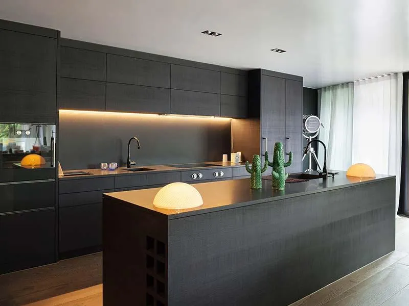 a newly remodeled kitchen with black cabinets