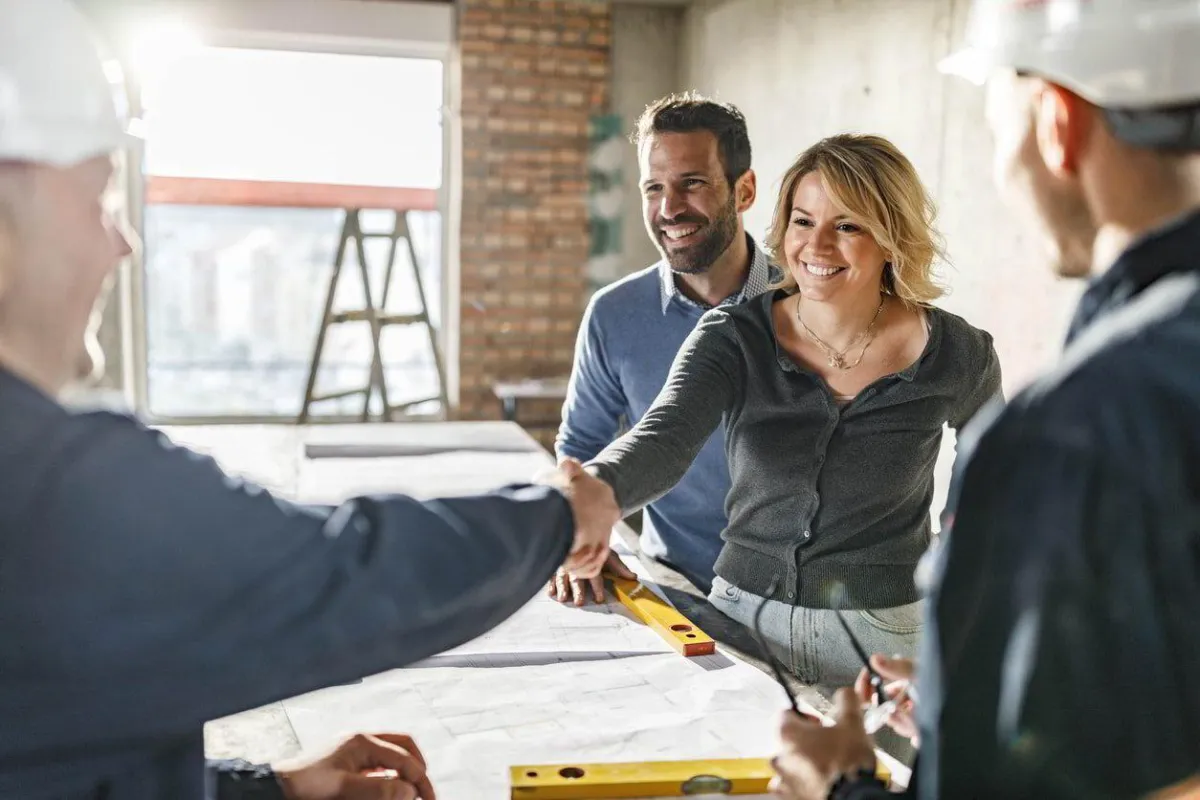 a client and the contractor shaking hands