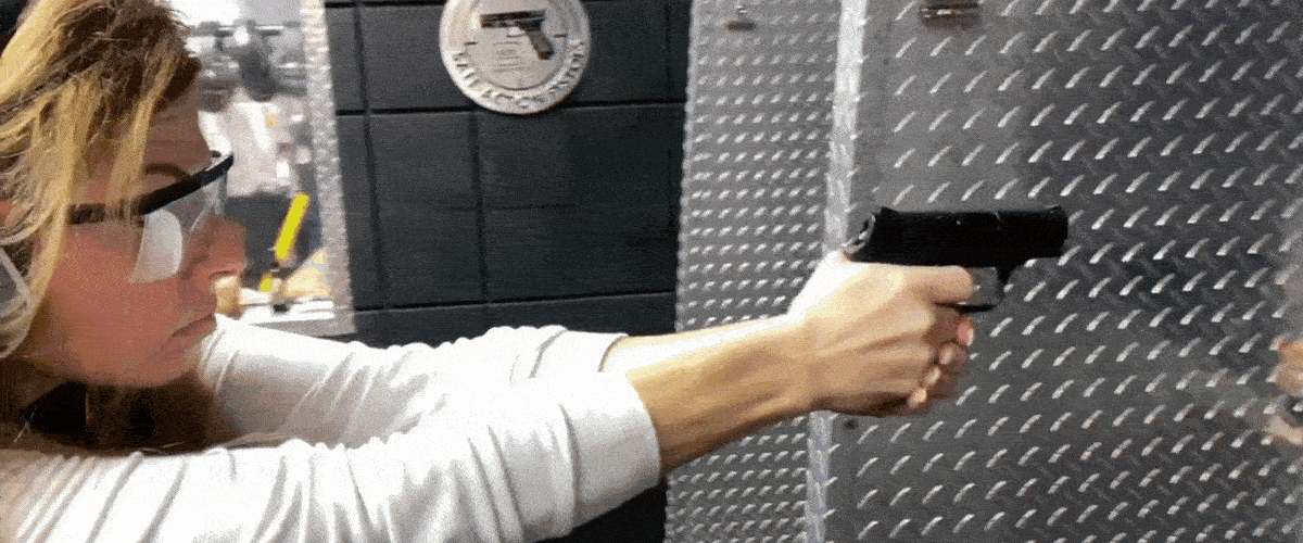 A famale gun owner practicing with her firearm at the range