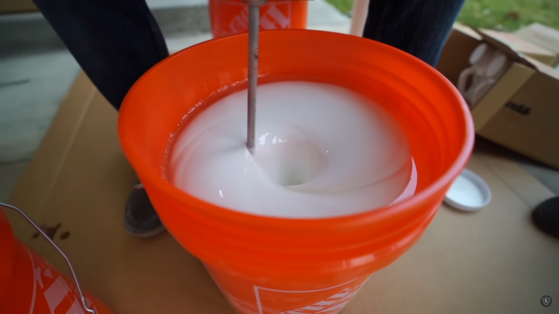 mixing epoxy paint in orange bucket