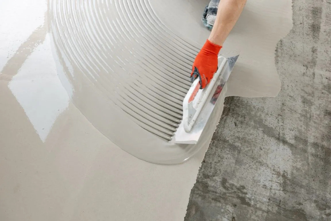 epoxy flooring contractor spreading grey paint