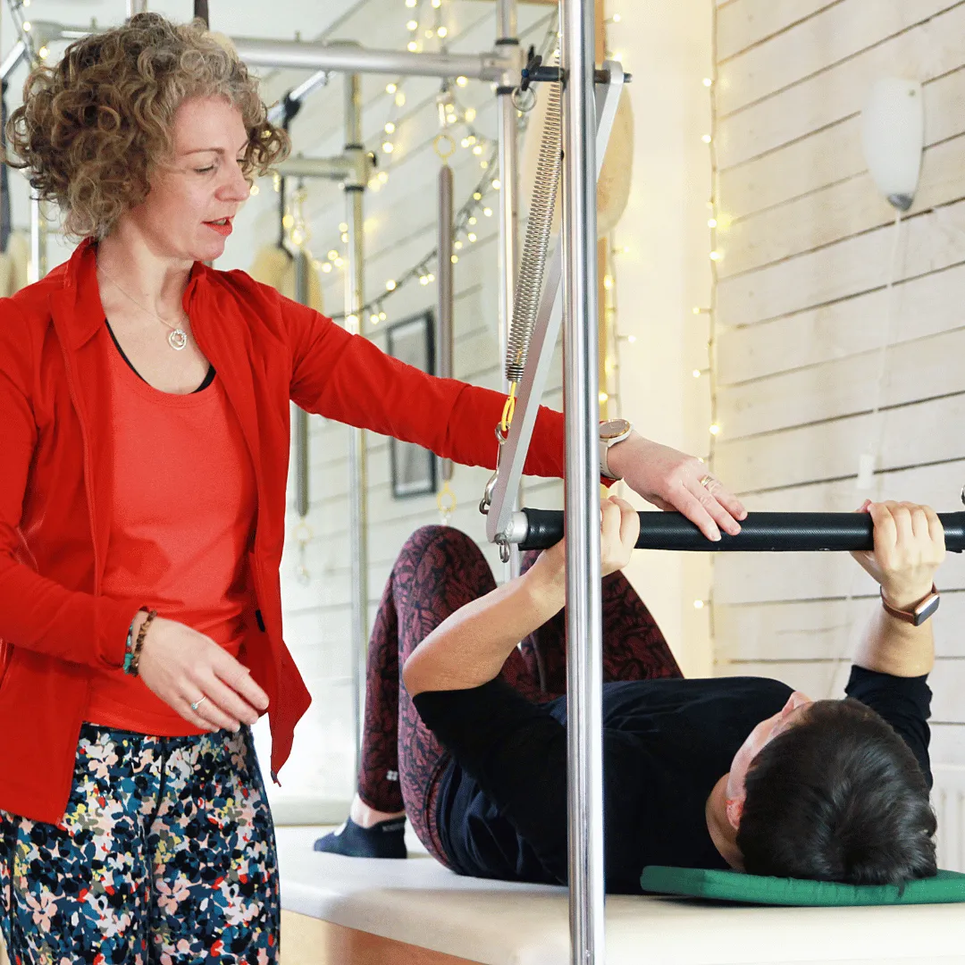 Claire teaching a woman about her pelvic