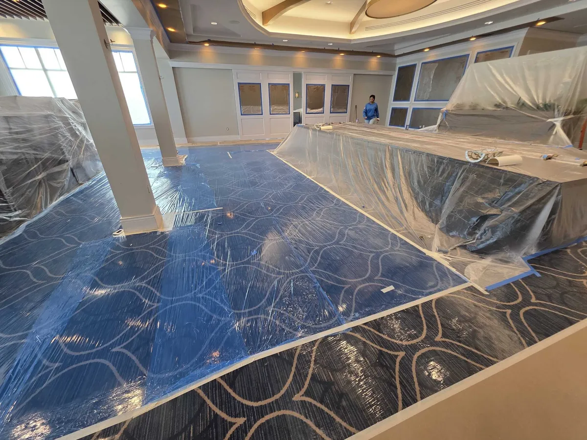 Floors covered with plastic before interior painting at Pelican Isles Yacht Club