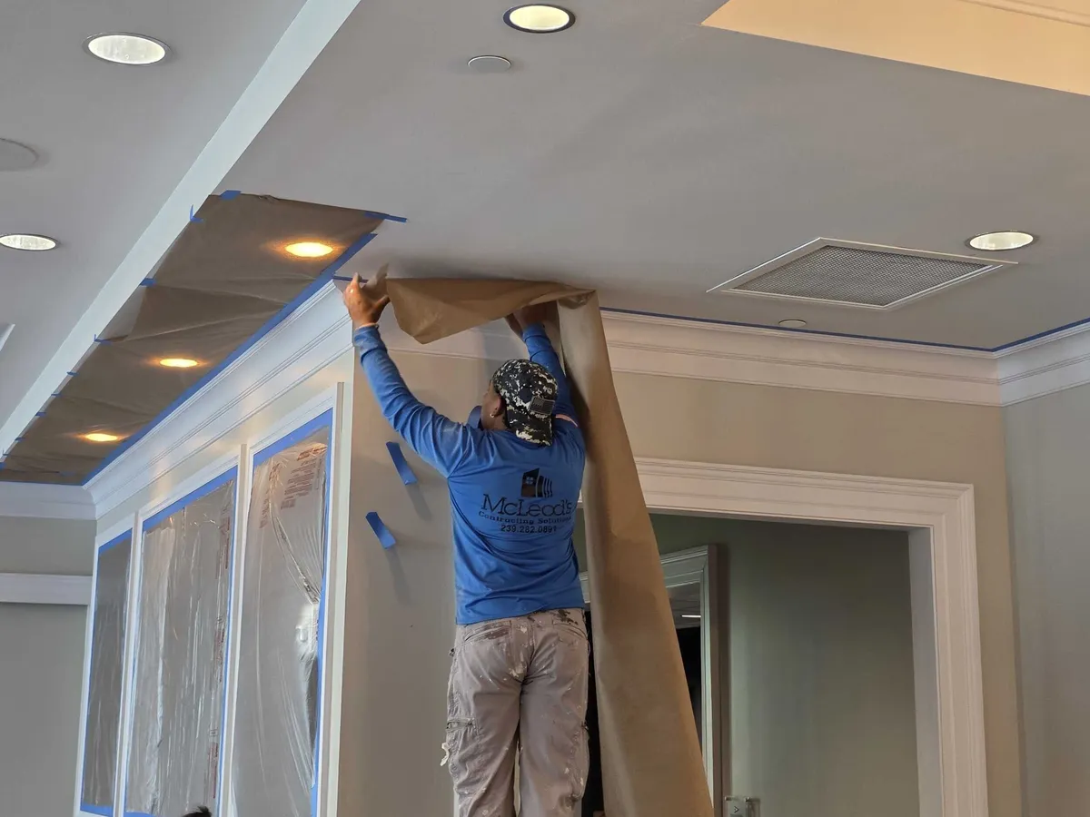 McLeod's Construction painter masking a doorway at Pelican Isles Yacht Club