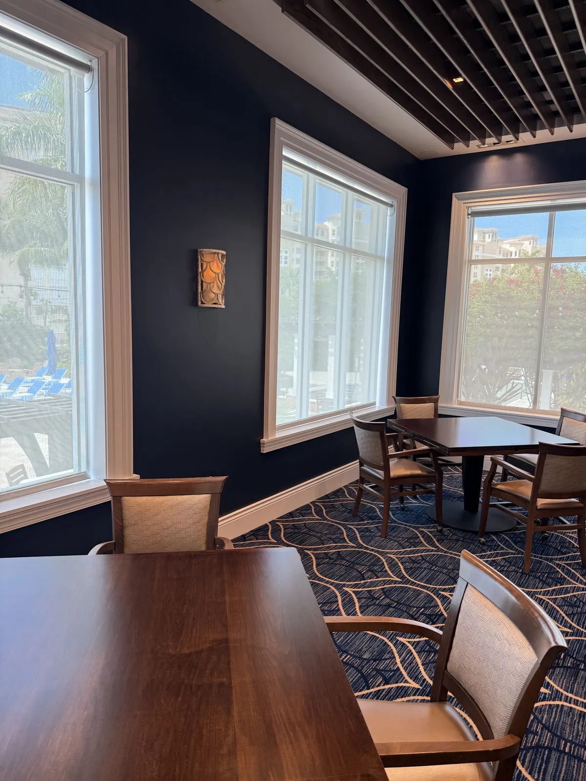 Navy accent wall and white trim in the Pelican Isles Yacht Club dining room