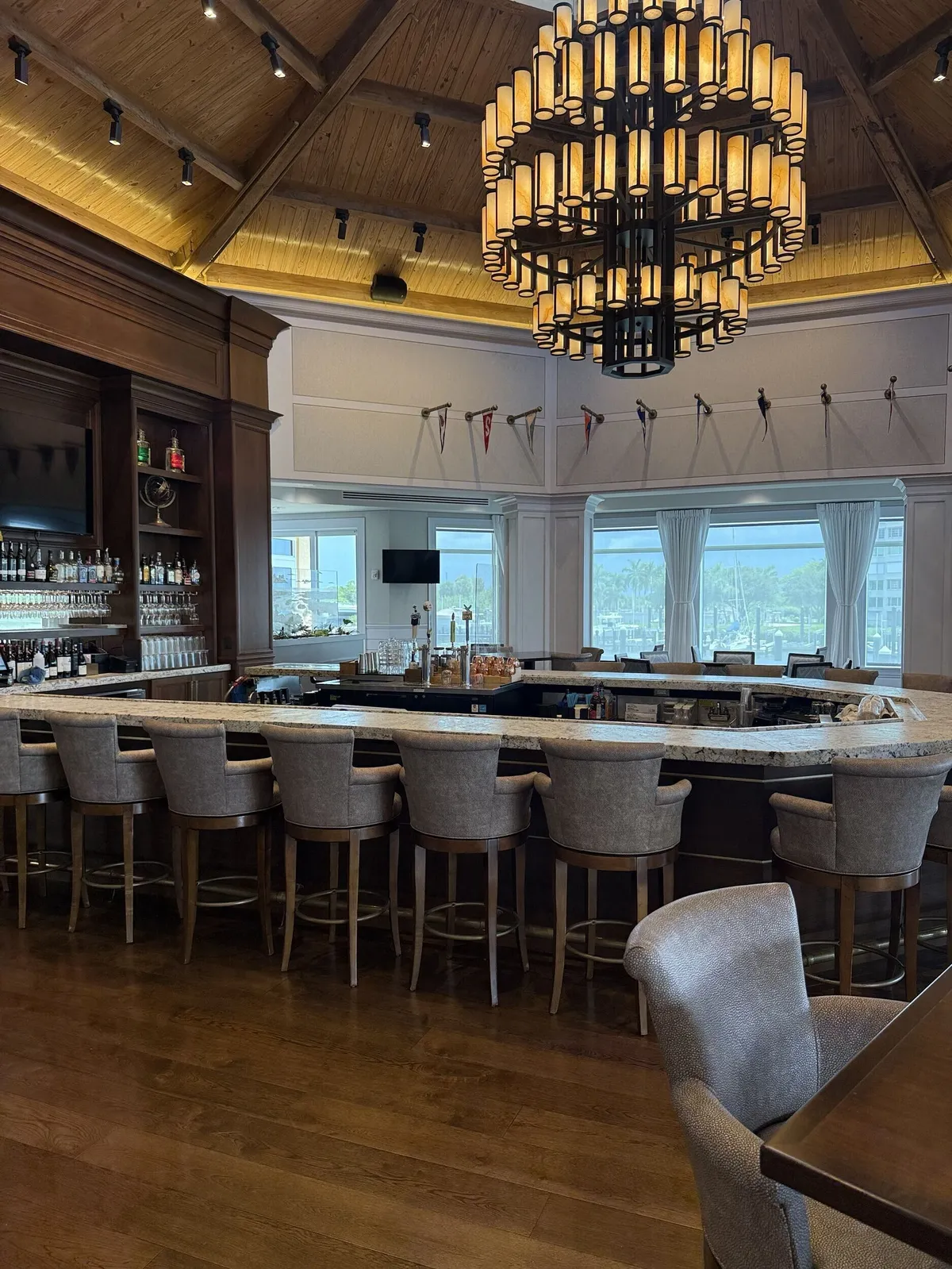 Pelican Isles Yacht Club bar with chandelier and freshly painted walls