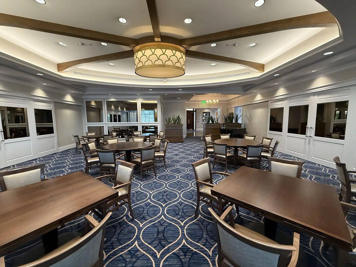 Pelican Isles Yacht Club dining room with chandelier and coffered ceiling after interior painting
