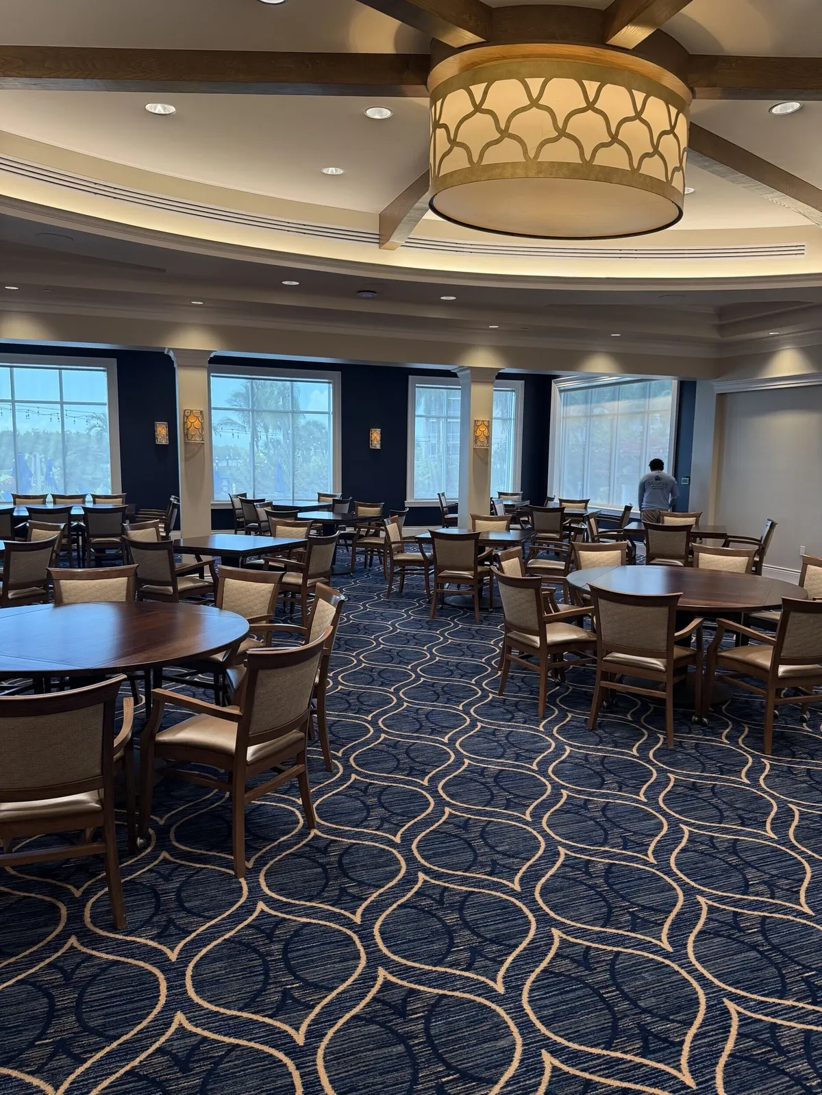 Pelican Isles Yacht Club dining room with repainted navy accent walls and windows