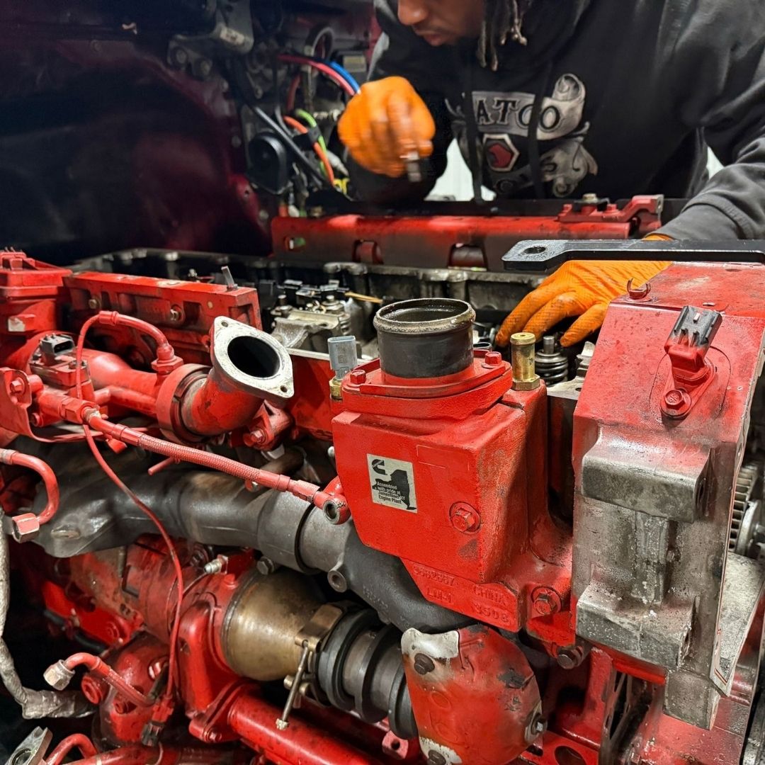 Close-up of red diesel engine components during truck engine repair