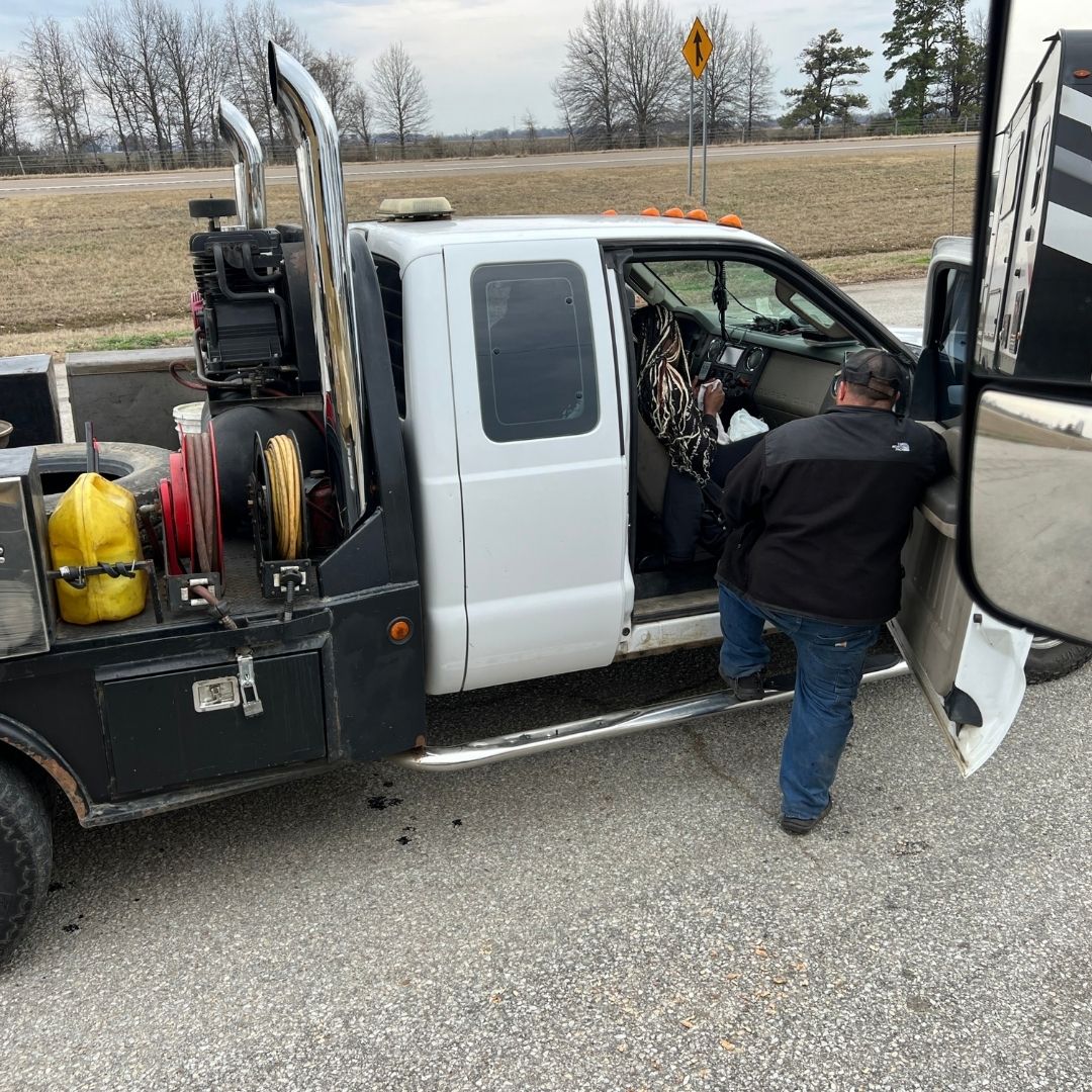 Mobile mechanic repairing a semi truck on the roadside near Memphis