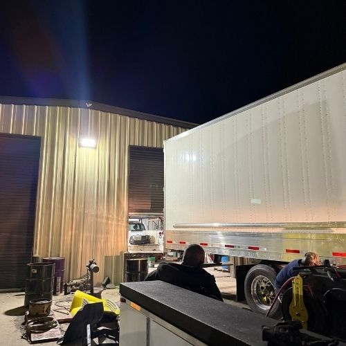 Night repair on a semi-trailer outside the shop