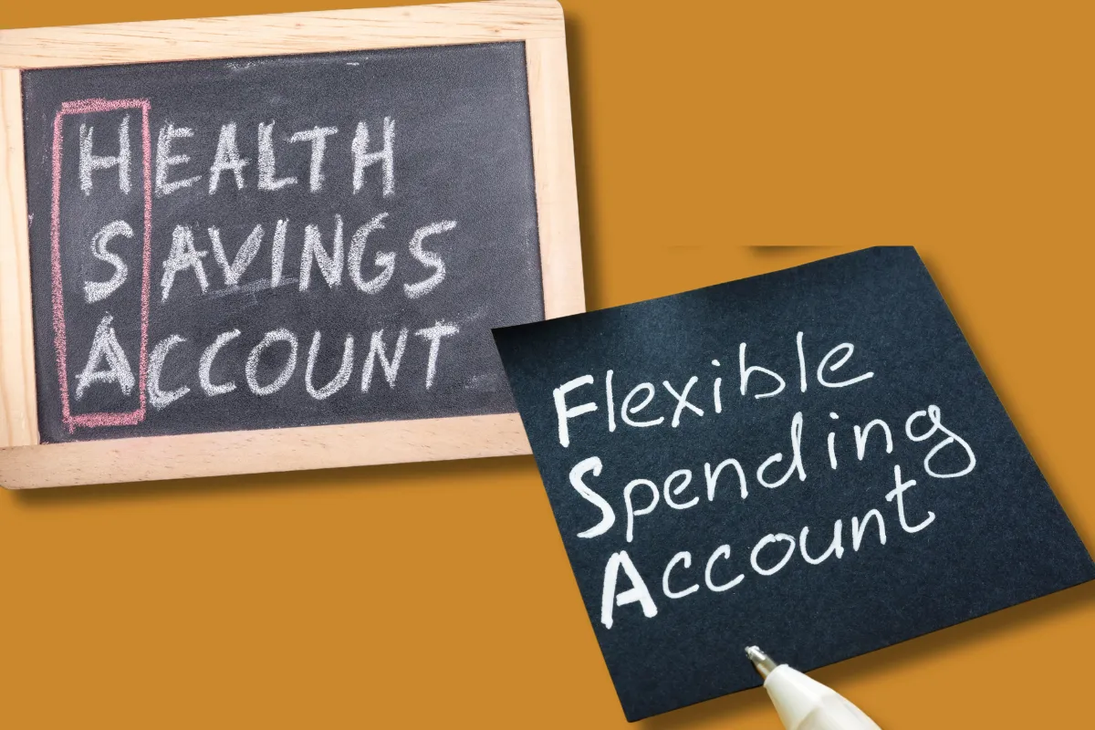 Side-by-side handwritten notes showing acronyms for financial health accounts. One chalkboard reads ‘HSA – Health Savings Account’ and another note reads ‘FSA – Flexible Spending Account,’ highlighting a comparison of the two healthcare-related financial options.