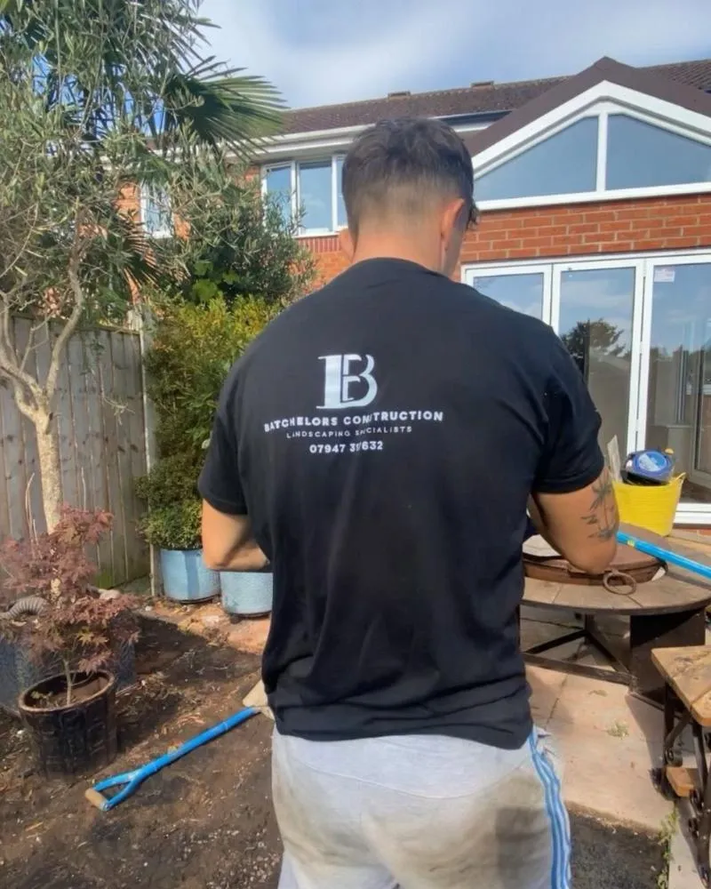 Lewis, expert landscaper in mansfield, wearing Batchelors Landscape's logo on his  lshirt