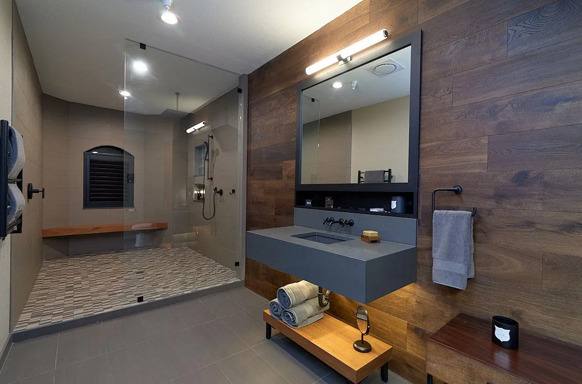 Contemporary bathroom with wood accent walls, floating vanity, walk-in shower, and modern lighting.