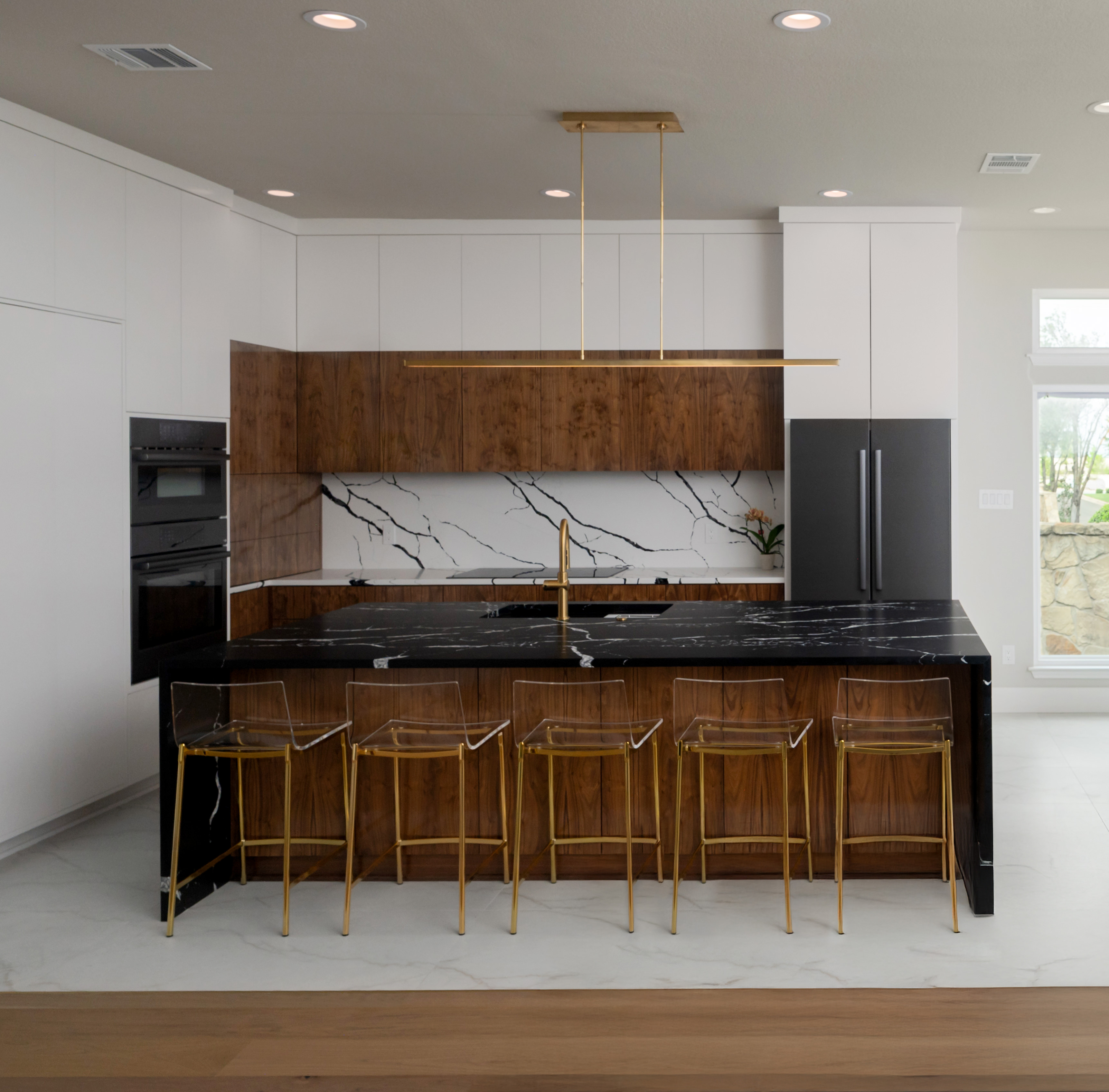 Two-tone kitchen with wood accents and waterfall island