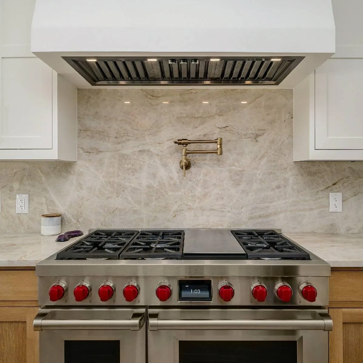 Stainless steel gas range with marble backsplash and pot filler