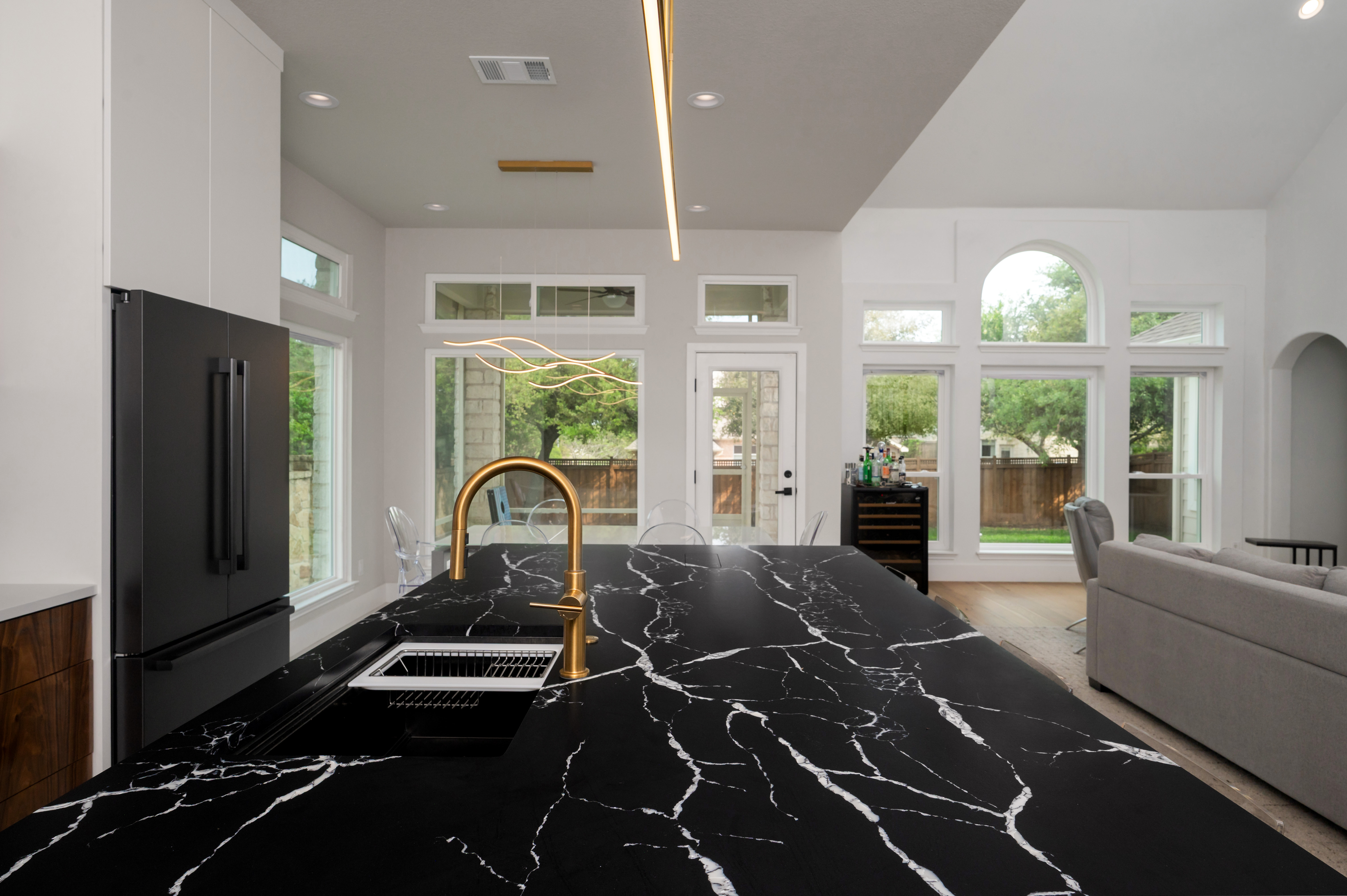 Cozy living space with a blue accent wall, modern fireplace, and neutral furniture.