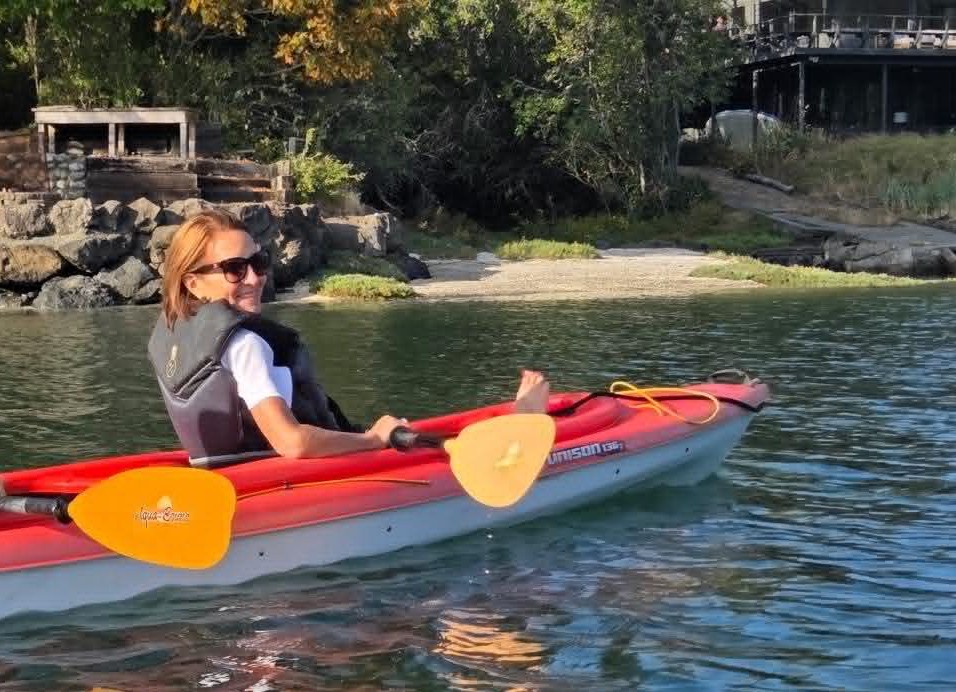 A scenic view of Bainbridge Island surrounded by calm waters, reflecting the beauty, community, and sense of peace found during a new chapter of life.