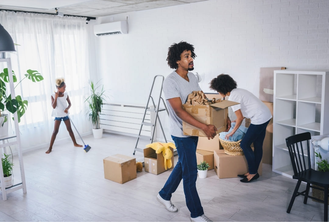 cleaners carrying boxes and cleaning up empty room for move-in or move-out services