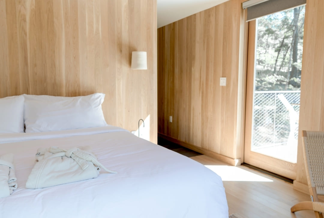 cleaning bedroom with natural wood vibes at an airbnb