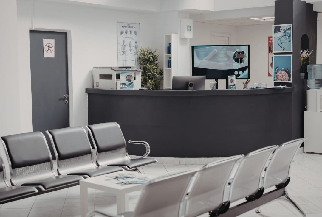 clean medical office with chairs and a nice receptionist desk