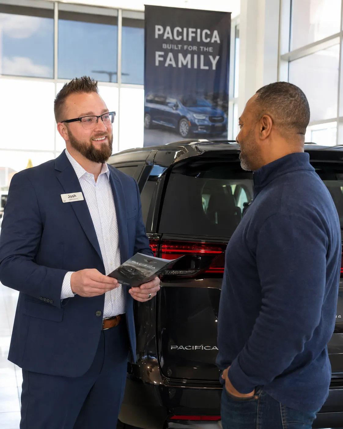 Person browsing luxury vehicles on a tablet