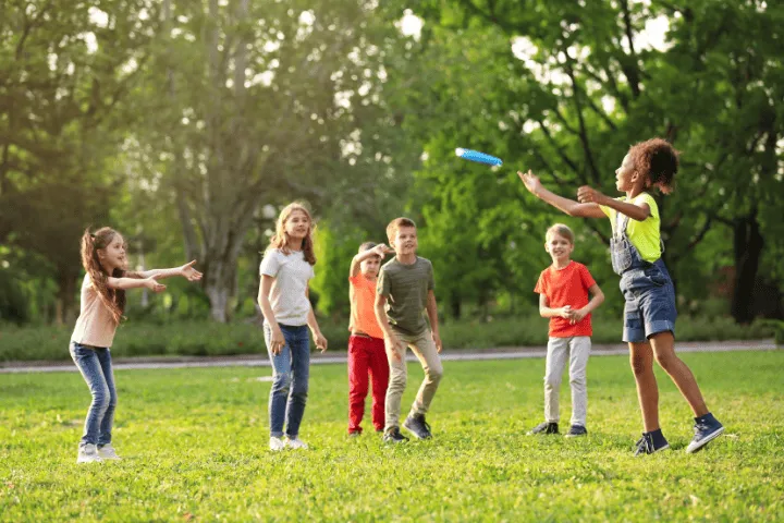 Children playing in a summer camp pogram outside