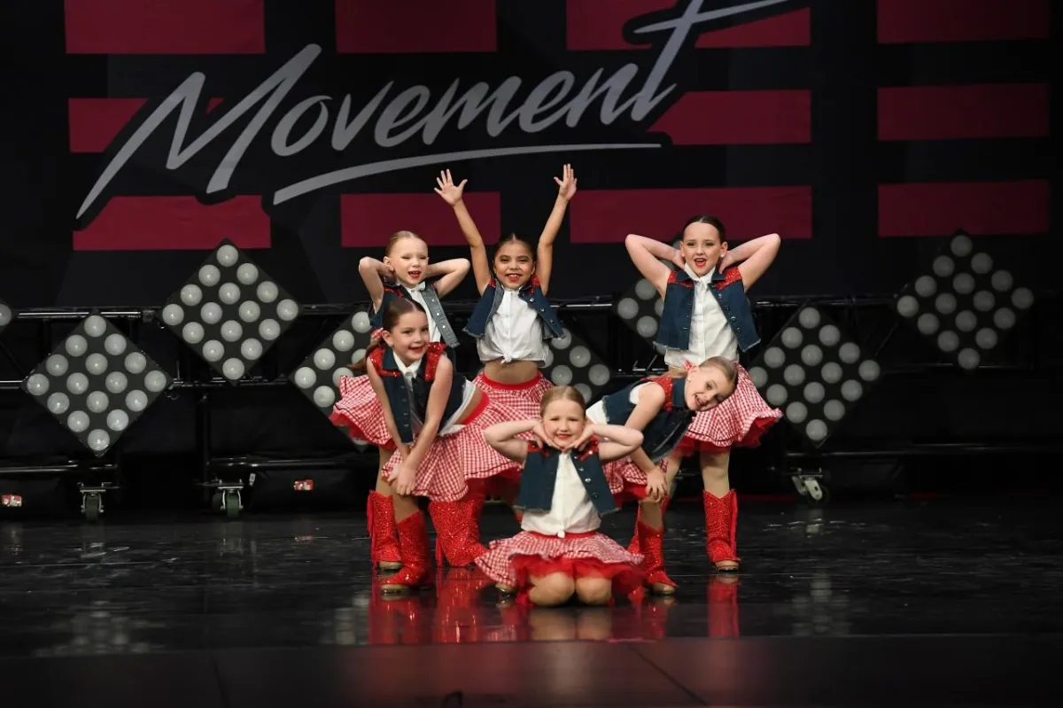 Dancers in red and white costume on stage